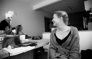 Candid moments during wedding preparations in a modern indoor setting.