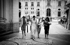 Black and white panoramic sequence showing people walking through a grand European city courtyard or plaza.