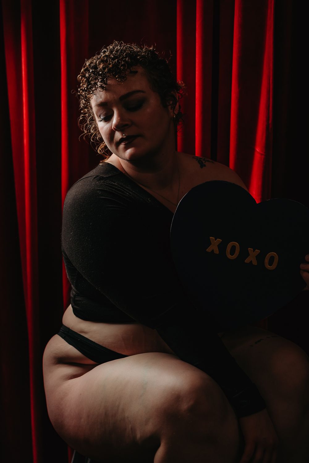 A dramatic series of six photos showing someone wearing a black hat against a red curtain backdrop.