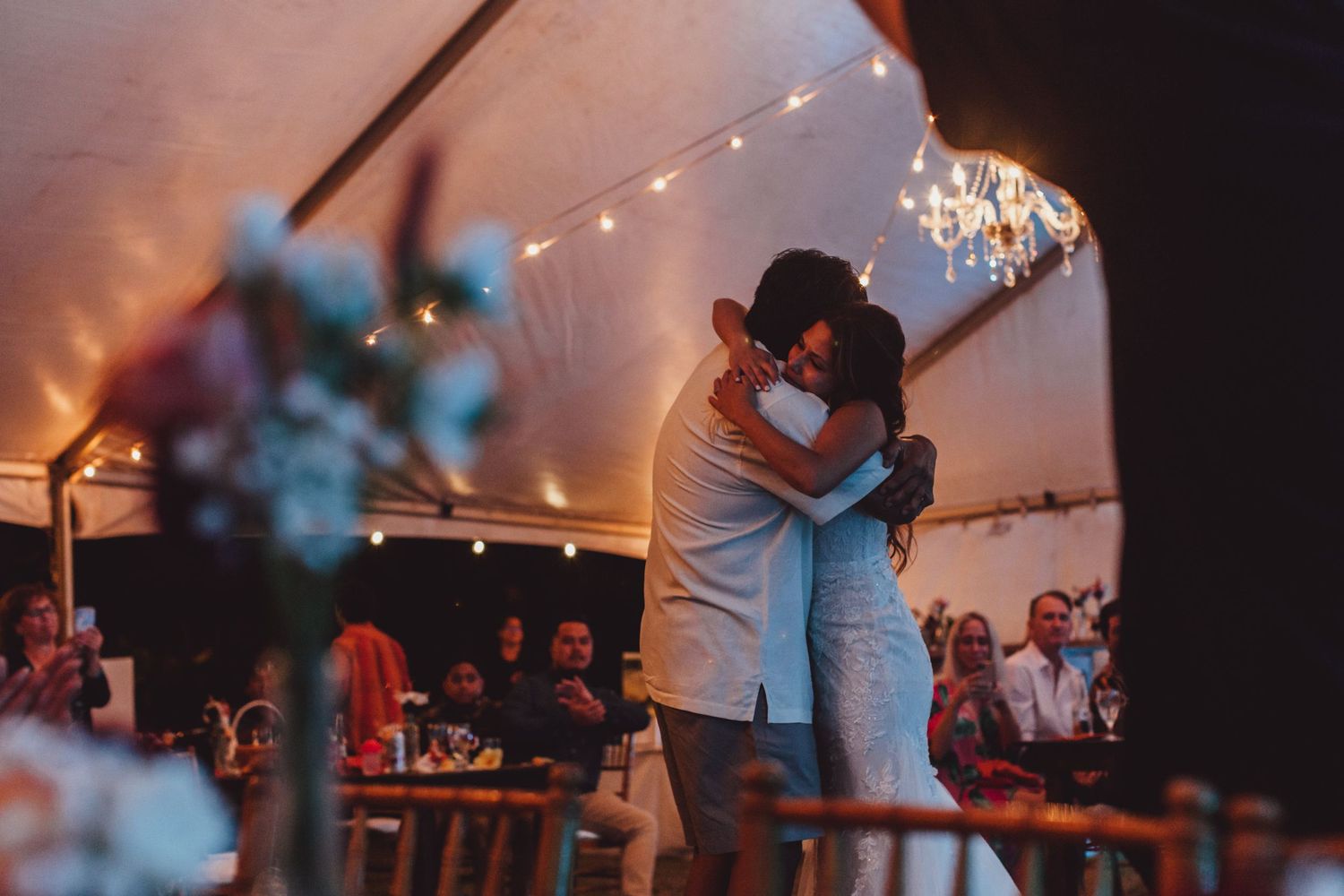 Wedding reception dance floor with string lights creating a romantic evening atmosphere.