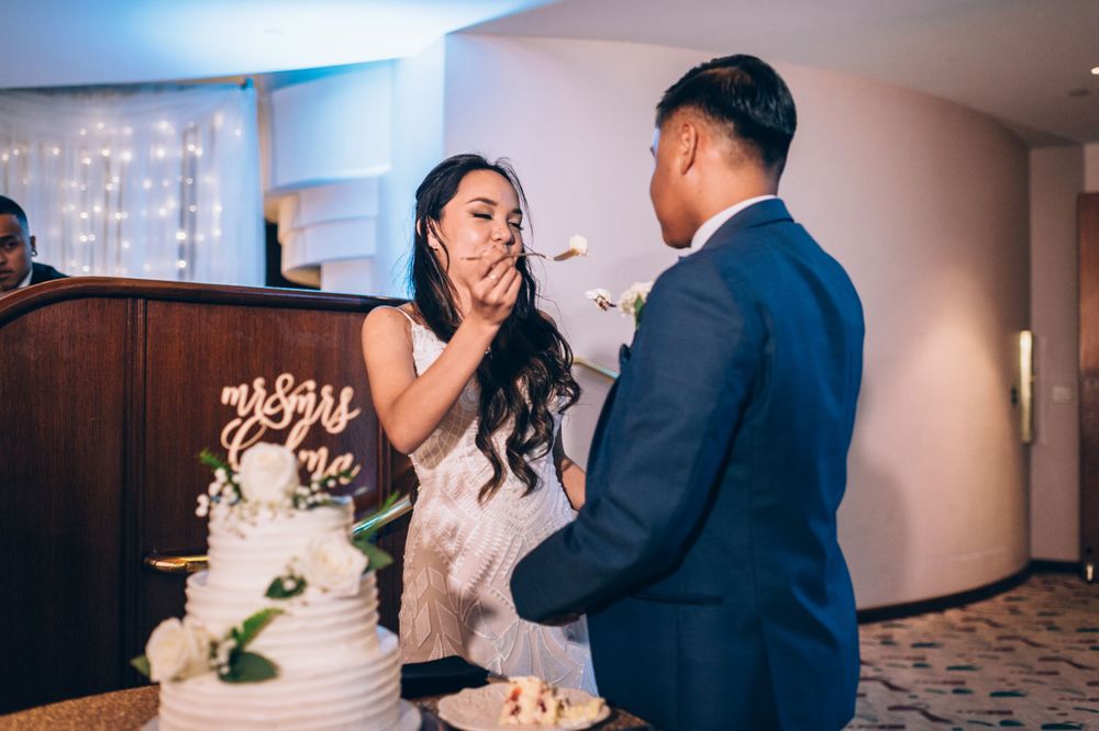 Couple sharing their wedding cake cutting moment during the reception.
