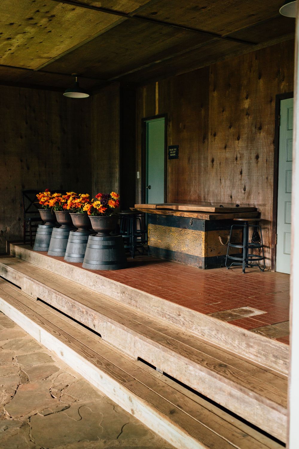 Interior view of a rustic wooden hall with tiered seating and traditional Hawaiian design elements.
