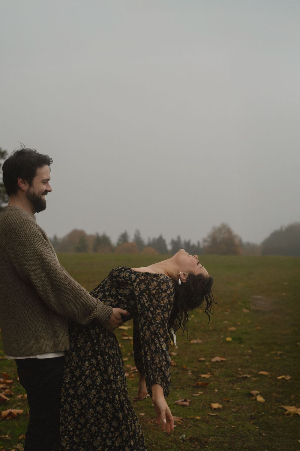 Playful autumn scene in misty field with fallen leaves.