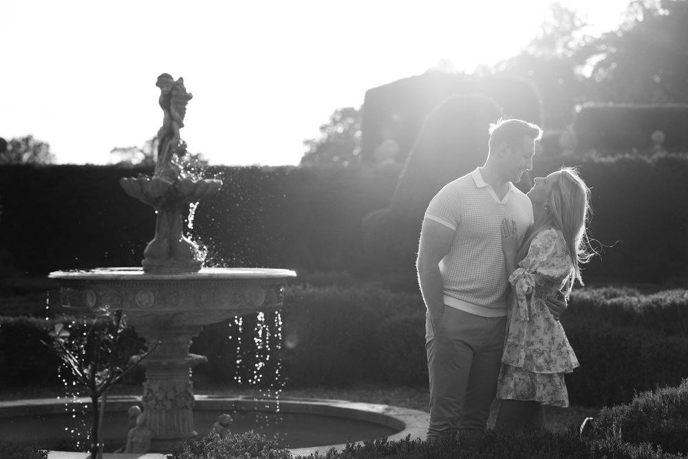 Silhouetted figures stand together at sunset in a backlit outdoor setting creating a romantic summer atmosphere.