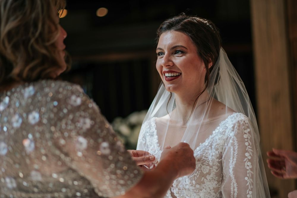 Elegant lace wedding dress details captured in soft lighting.