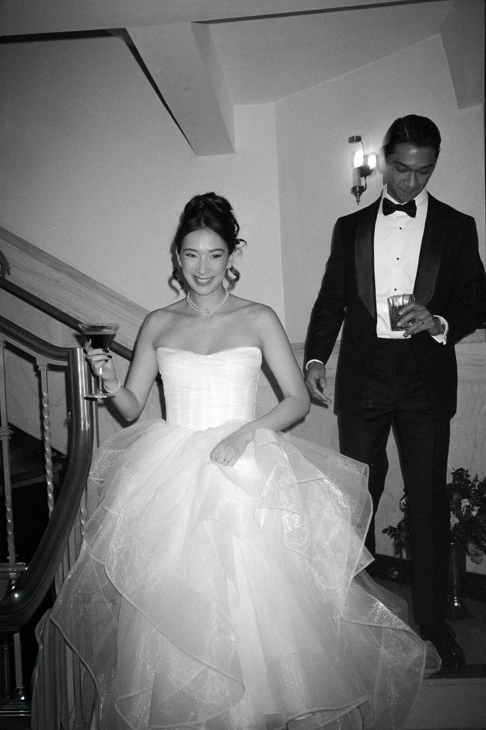 A series of black and white wedding photos showing a bride in a strapless ballgown dancing at a reception.