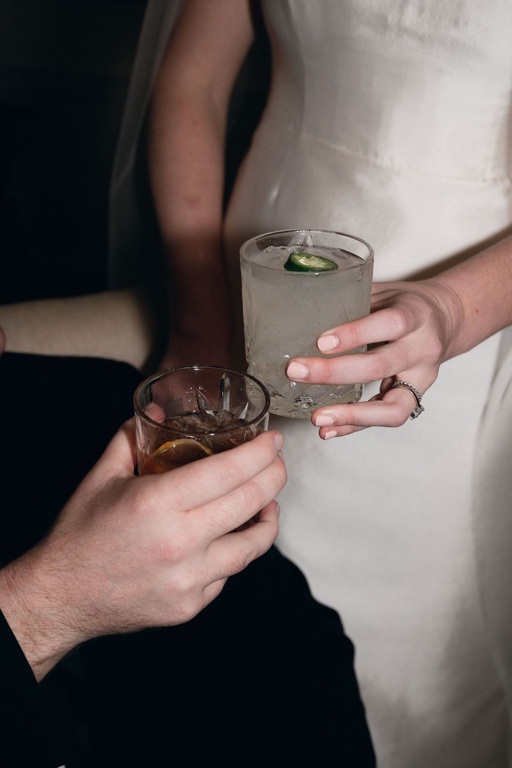 Hands holding various cocktail glasses against a dark background with white clothing visible in a progressive sequence.