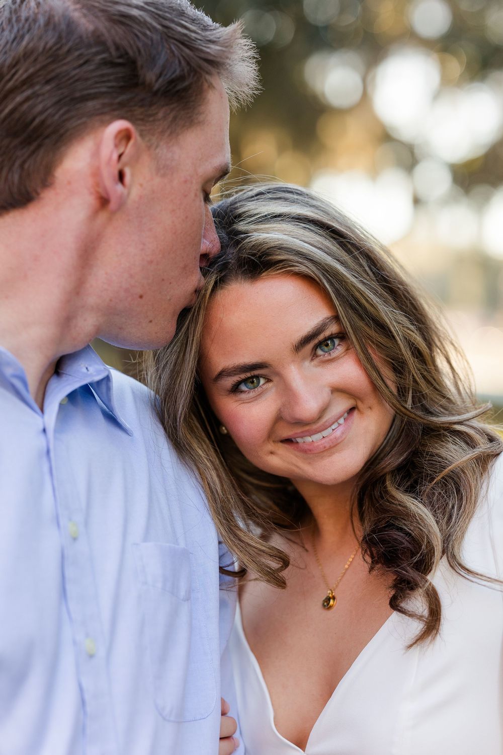 Close-up portrait shots of a couple sharing intimate moments against a soft bokeh background.