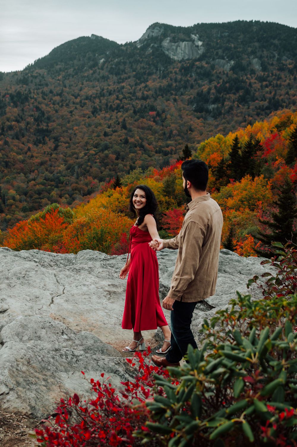 Romantic fall engagement photos of couple and puppy at Rough Ridge Overlook in Asheville, North Carolina.