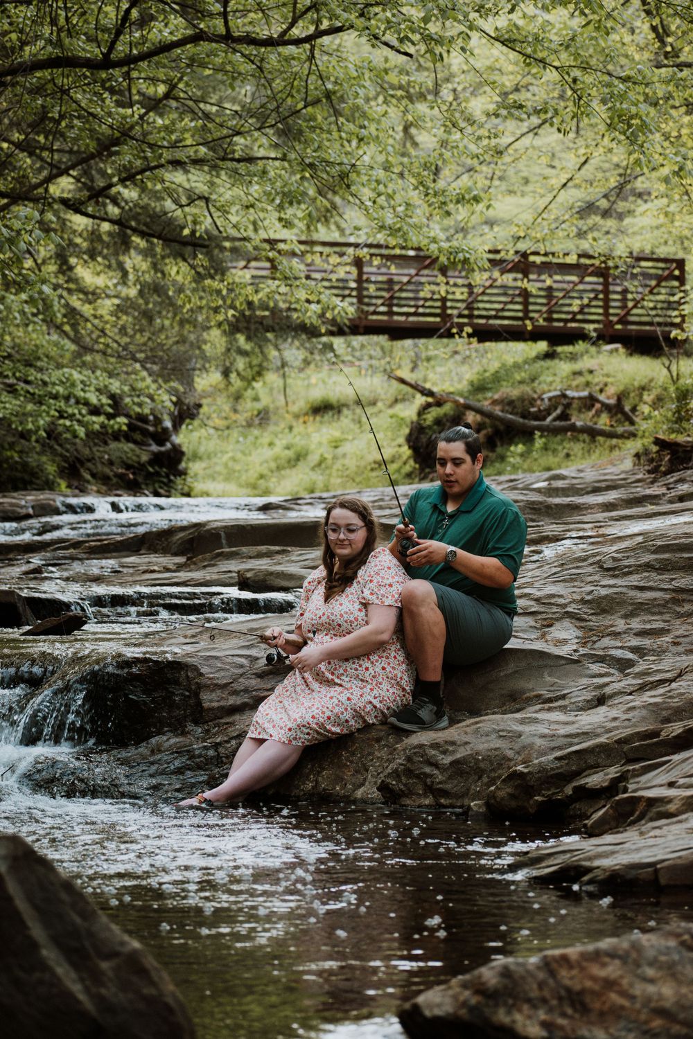 Asheville, NC engagement session of couple fishing at the Asheville Botanical Garden.
