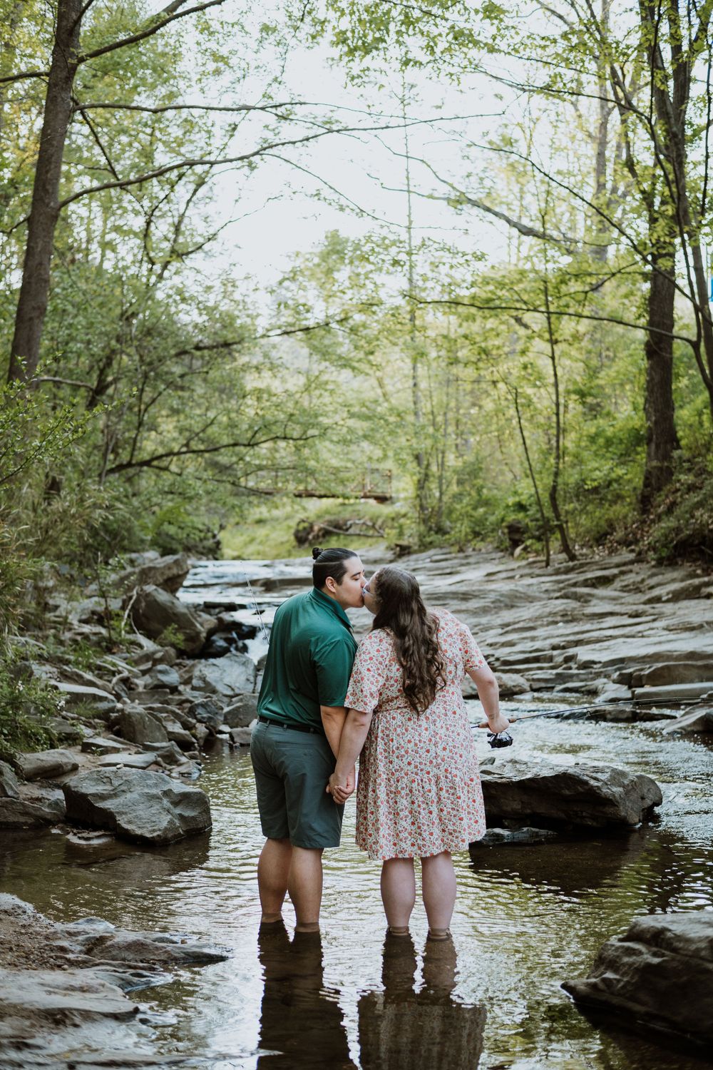 Asheville, NC engagement session of couple fishing at the Asheville Botanical Garden.