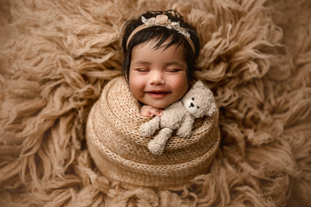 A series of warm-toned newborn photography portraits featuring soft textures and neutral beige colors.
