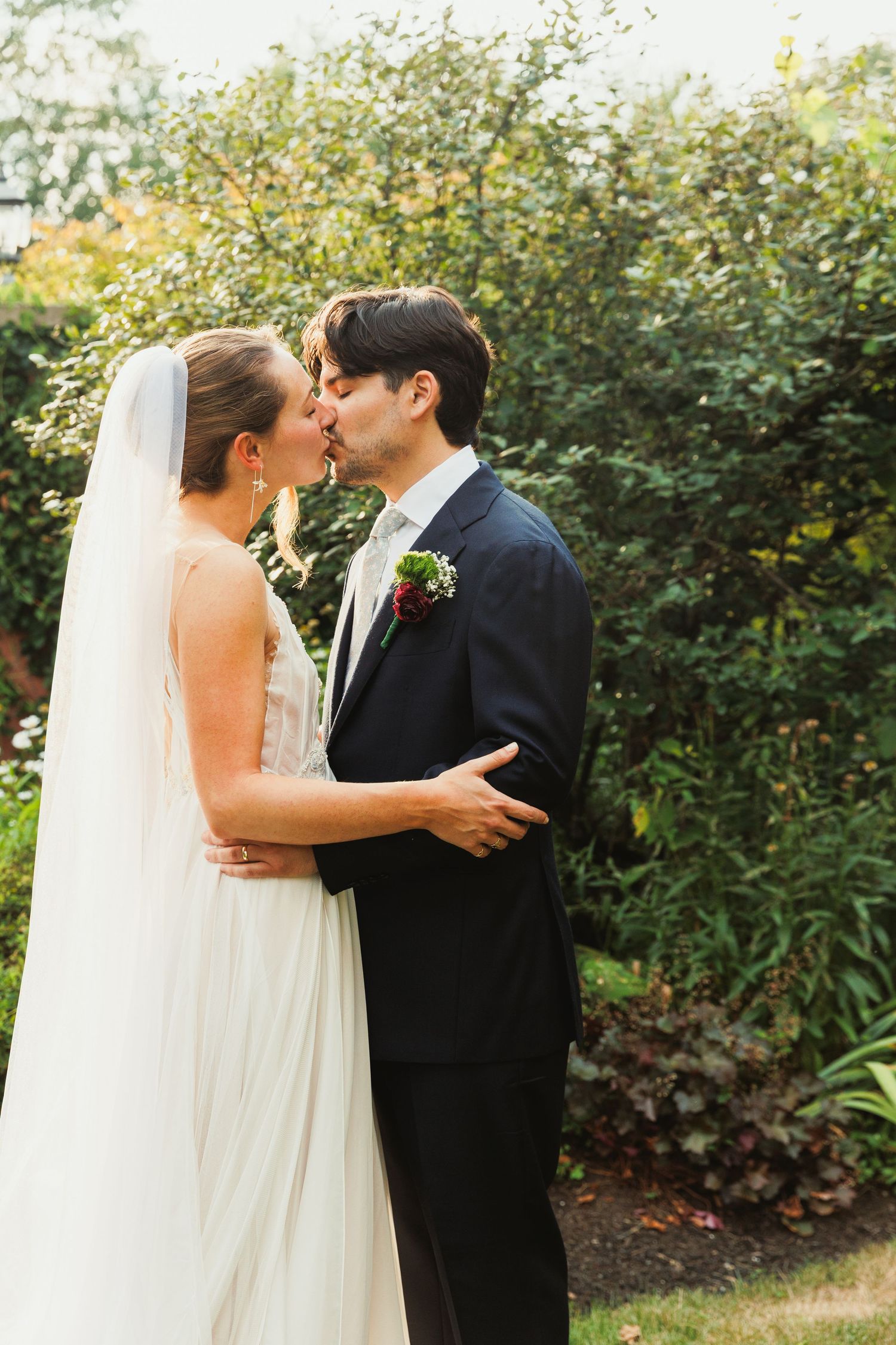 Tender wedding moments captured in a series of romantic garden photographs.