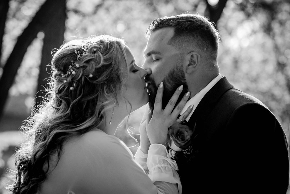 Wedding photography capturing a bride and groom kissing during their first look in Beaverton, Ontario.