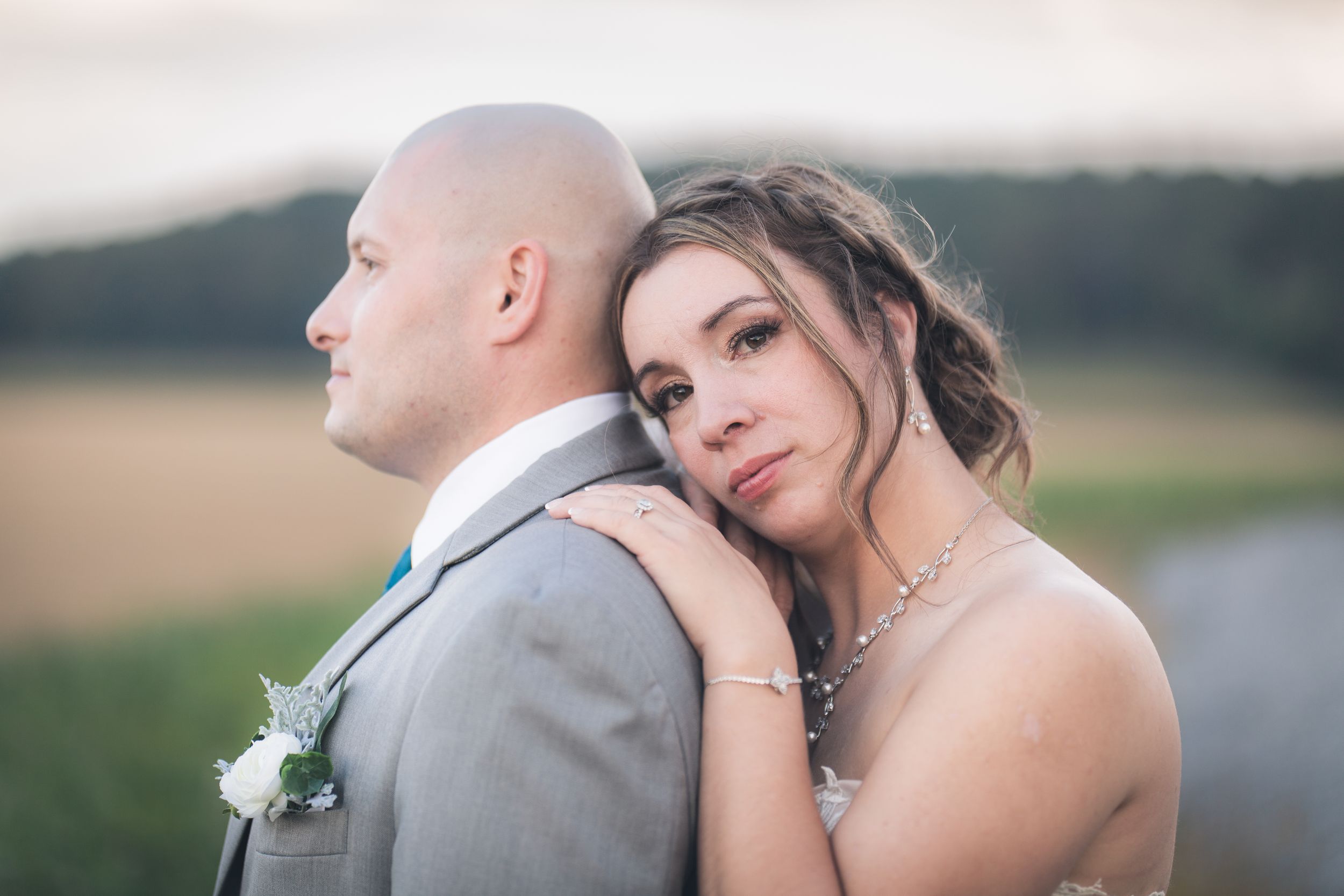 Sunset wedding portraits captured in a serene countryside setting.