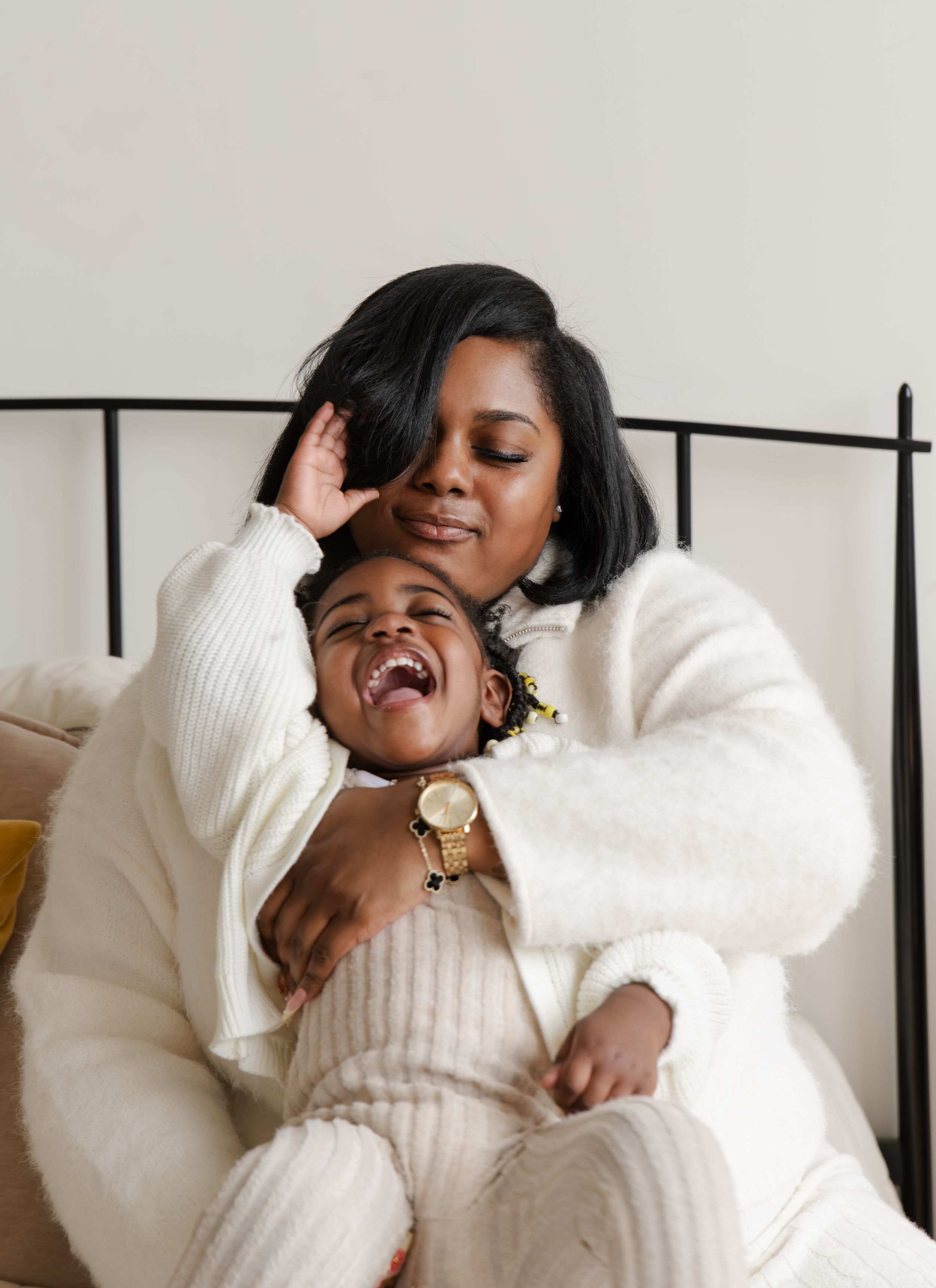 A person in a cozy white sweater poses expressively in a series of four connected artistic portrait shots.