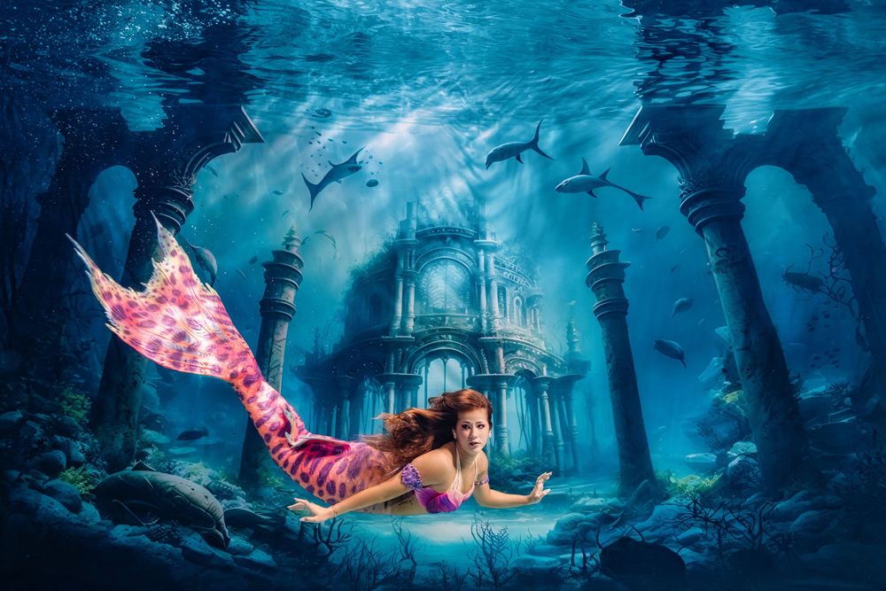 A series of underwater fantasy scenes with mermaids swimming through mystical blue environments with glowing lights.