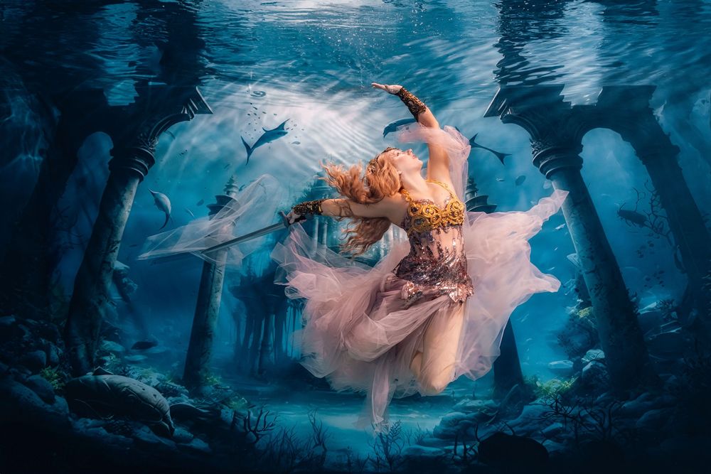Ethereal underwater fashion photography series featuring flowing fabric in dreamy blue ocean environment.