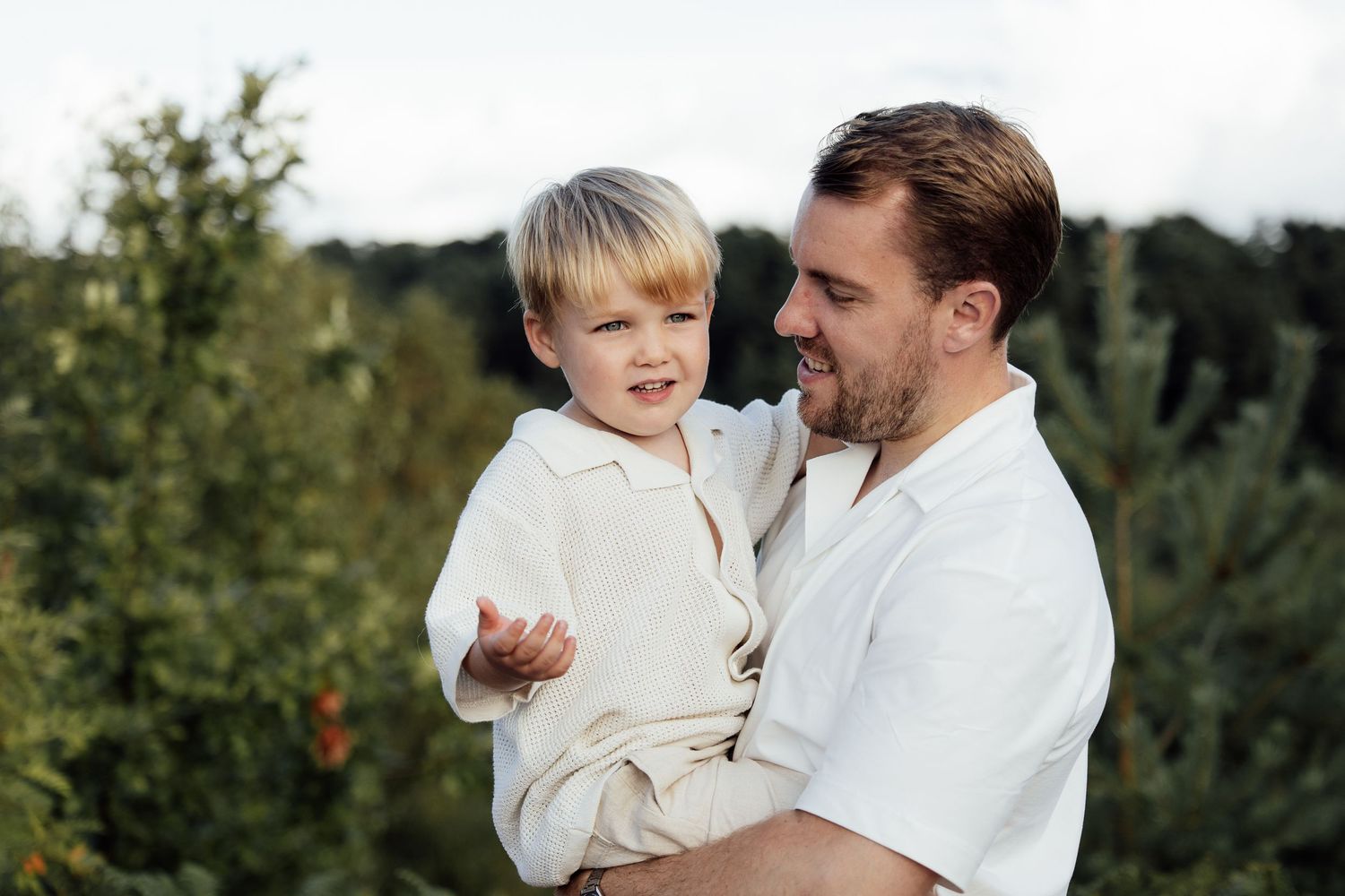 Father and son moment.  Dad is holding little boy and talking to him