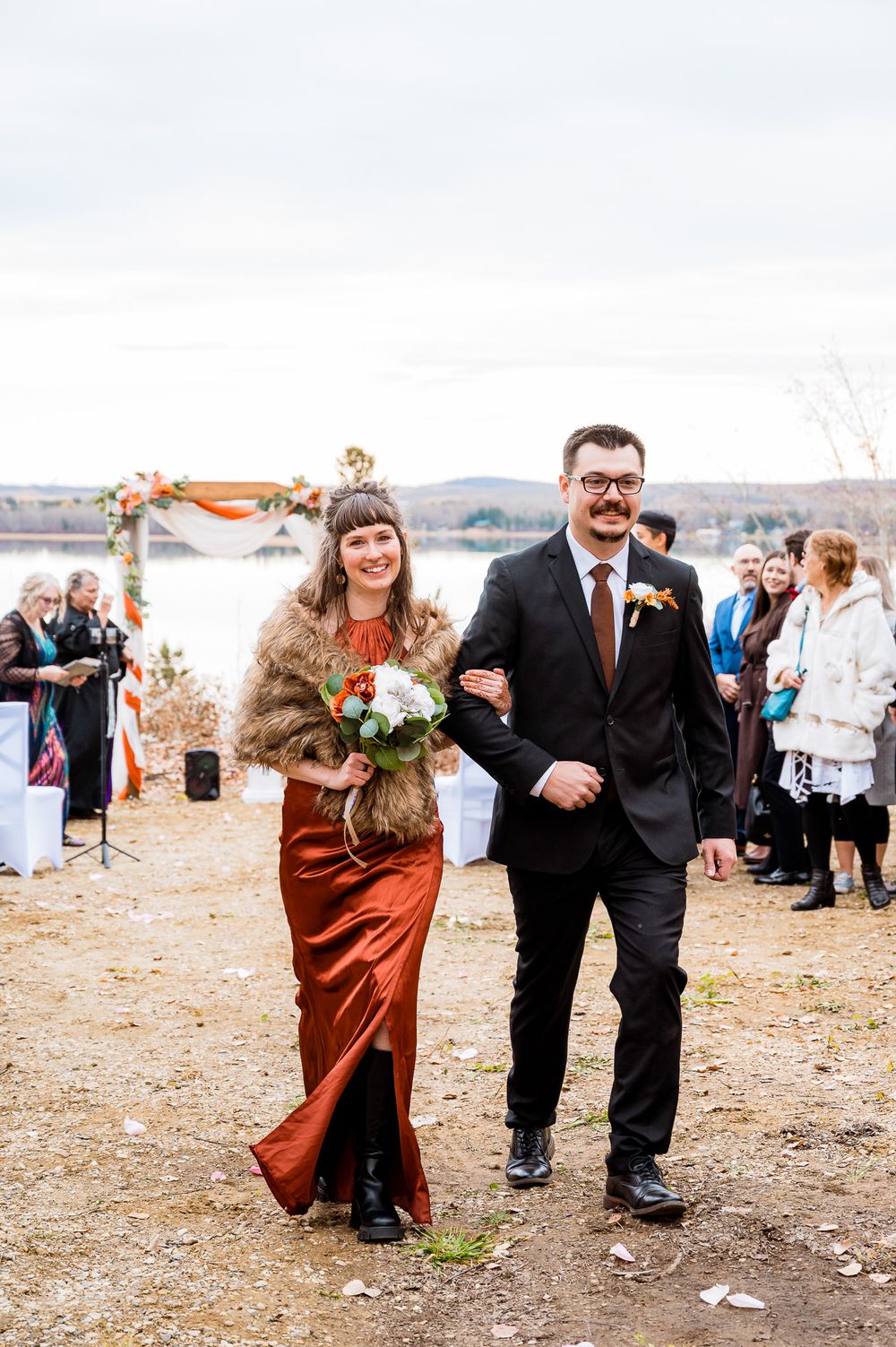 Wedding guests walk along a scenic outdoor path during an autumn celebration. kokanee springs rv park