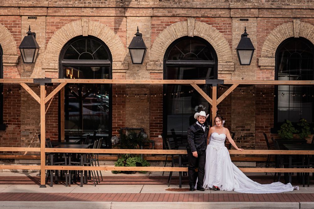 A bride and groom posing outside their wedding venue in Lindsay, Ontario.