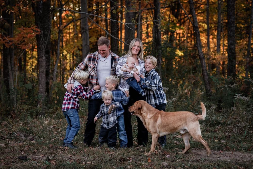 Parents laughing with their five boys and family dog at their ranch in Bolsover, Ontario.