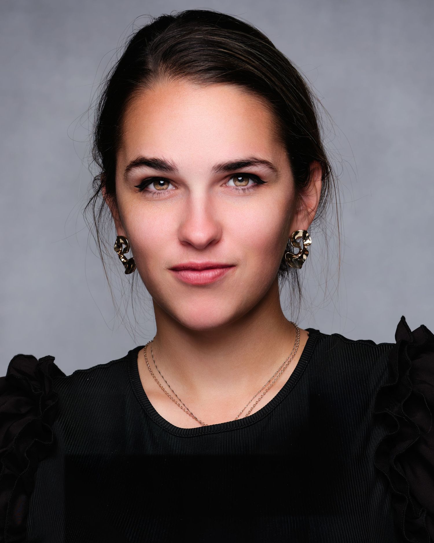 David G Holt Photography - Studio portrait series with black outfit against grey background showing different expressions.