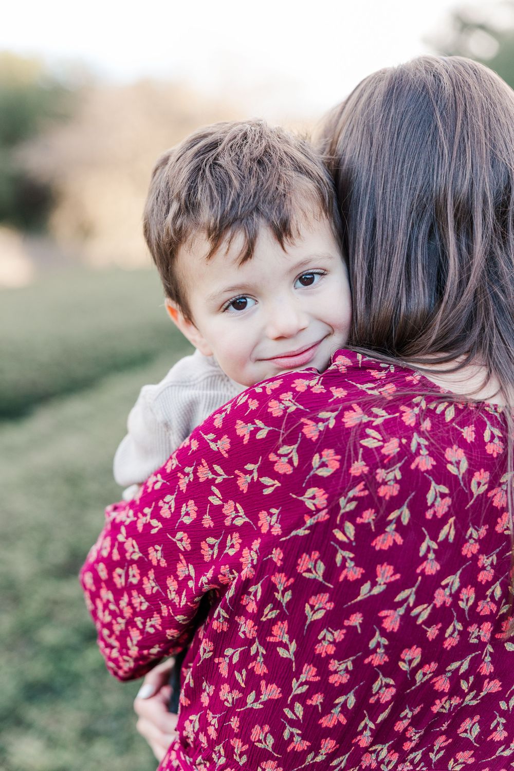 A series of candid photos showing a child wearing a burgundy floral dress hugging someone in an outdoor setting.