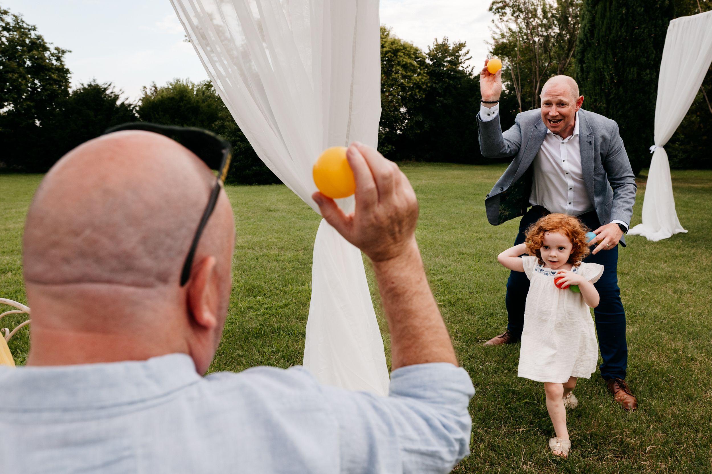 A sequence of candid wedding photos showing guests dancing and celebrating at an outdoor reception.