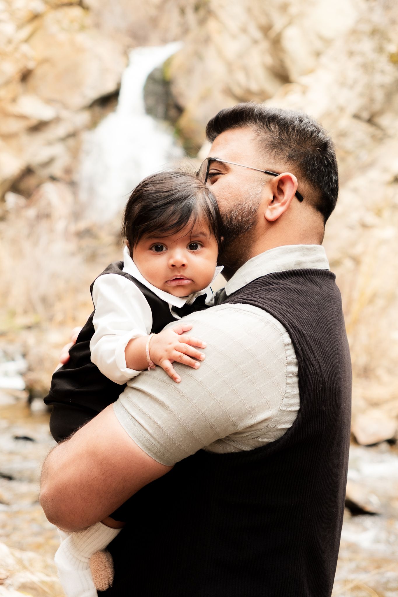 Family photo series in indoor garden setting with people wearing coordinated neutral tones.