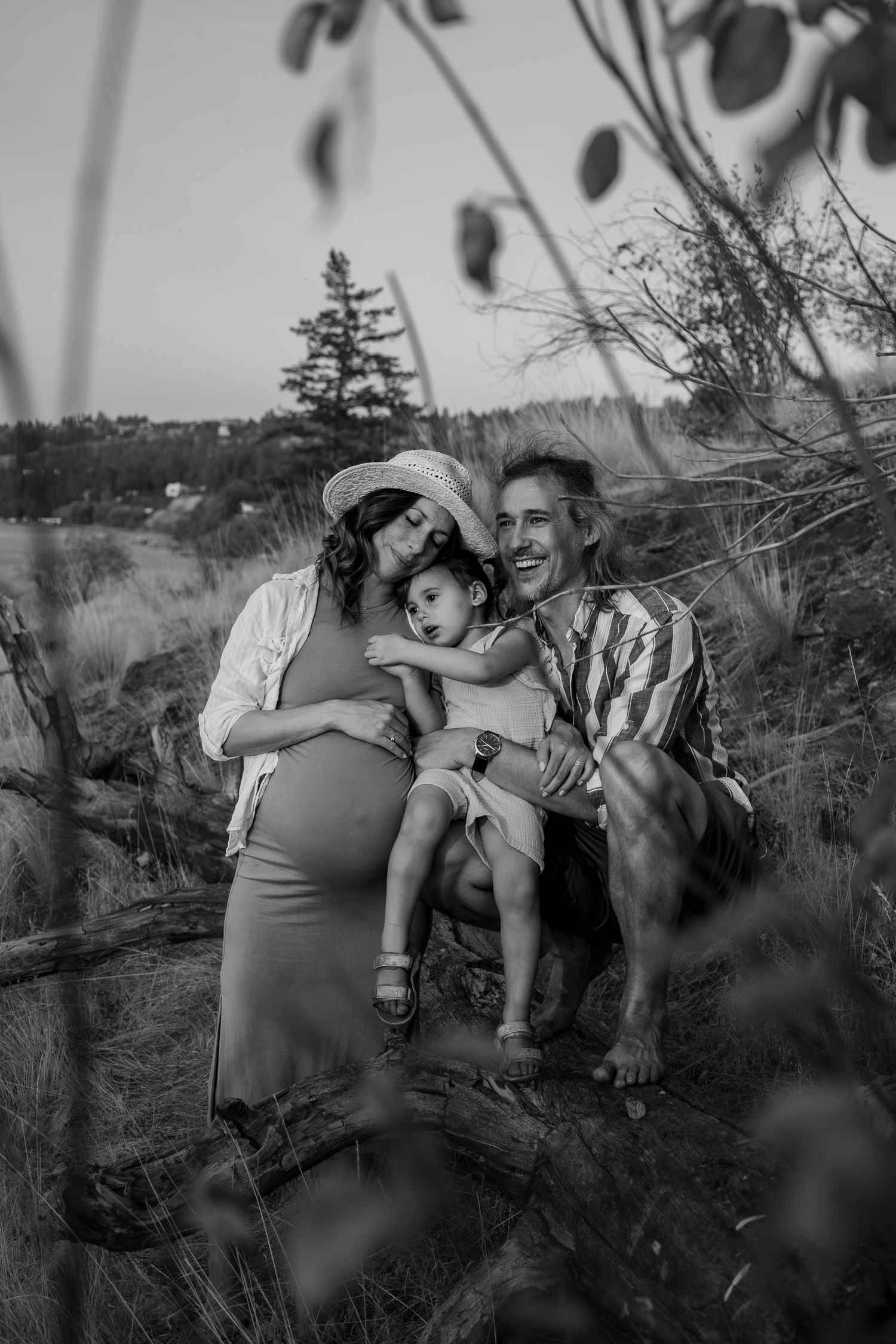 Family photo series in indoor garden setting with people wearing coordinated neutral tones.