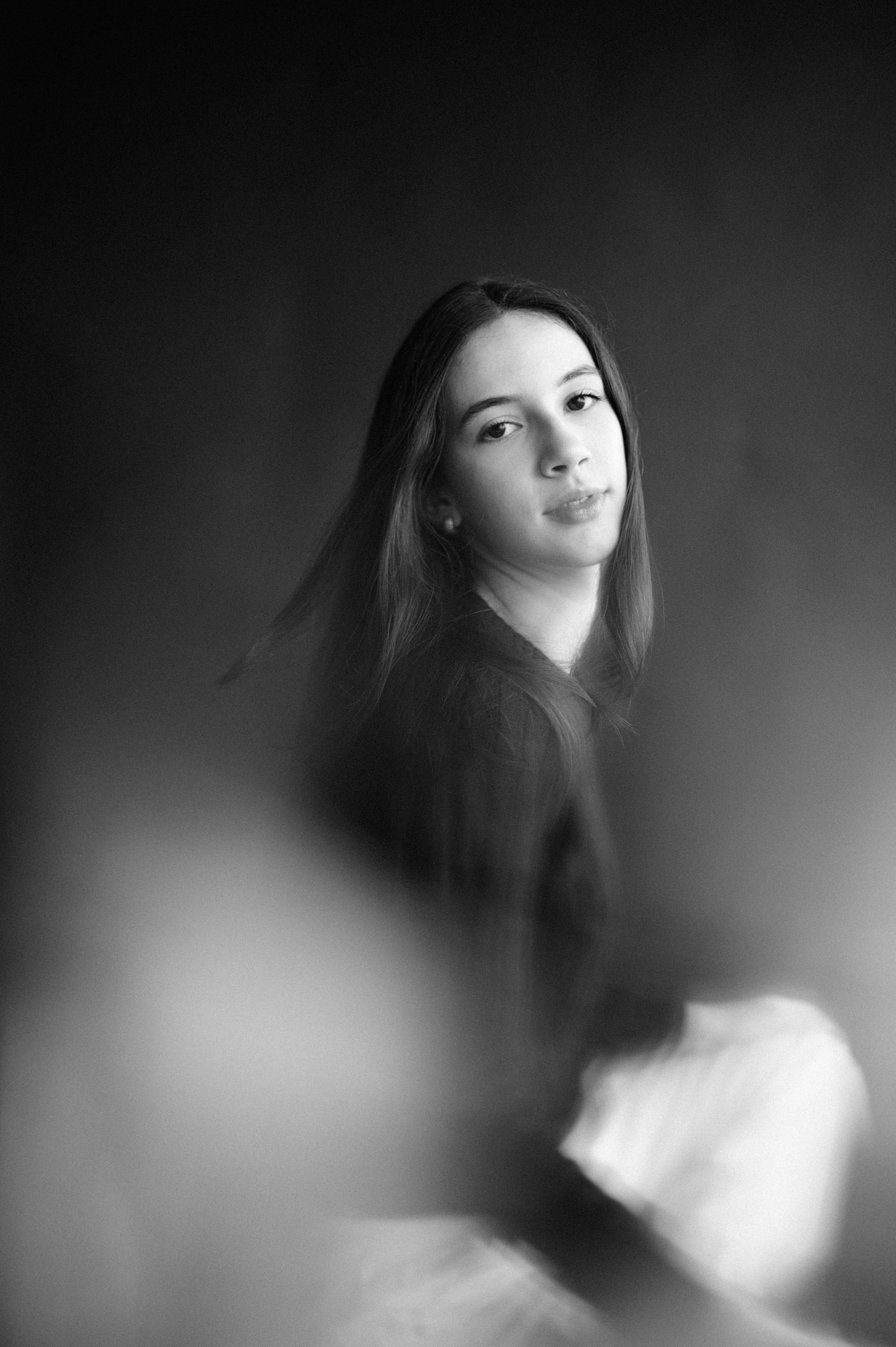 Dreamy black and white portrait with soft motion blur effect.