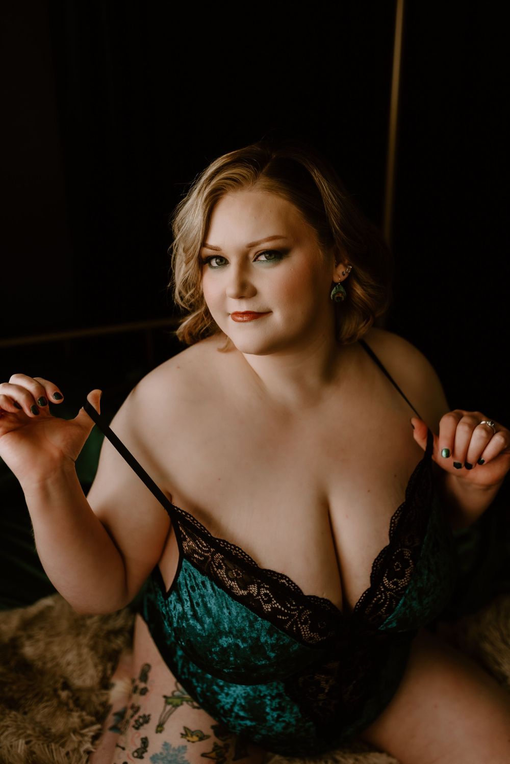 Intimate portrait in emerald green velvet and black lace lingerie.