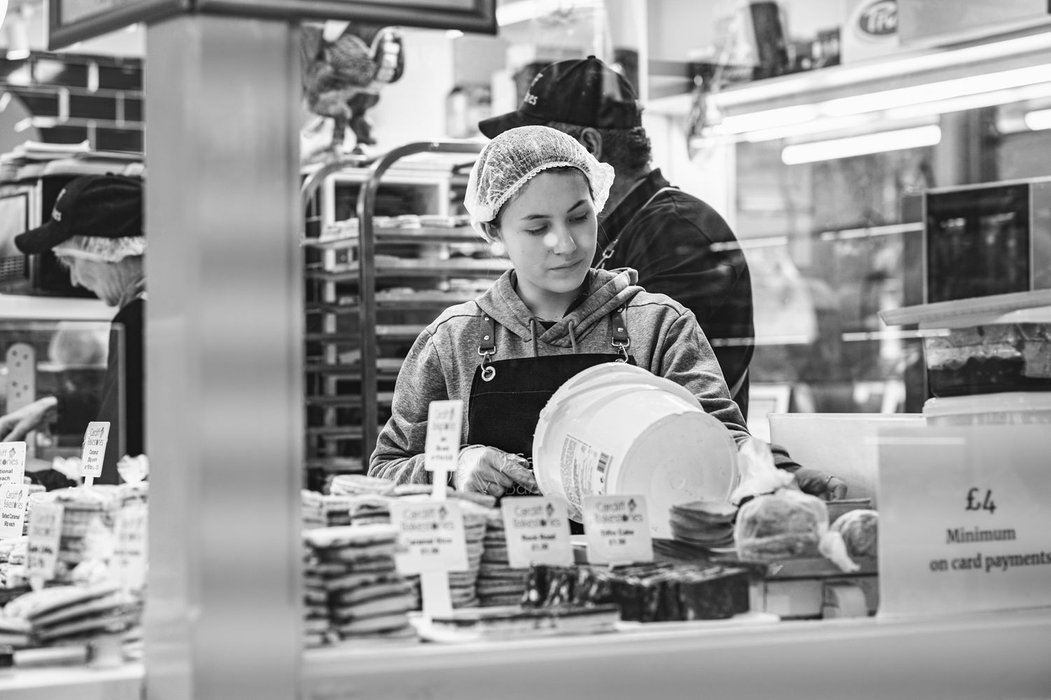 Black and white picture of a woman mixing dough to make welsh cakes candid corporate photography in Cardiff, South Wales