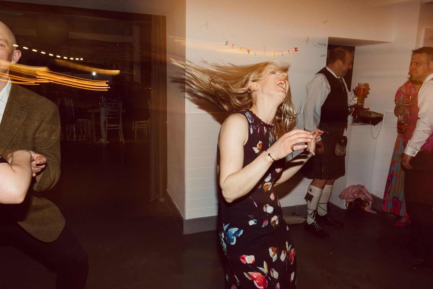 Wedding reception guests dancing and enjoying the party atmosphere.