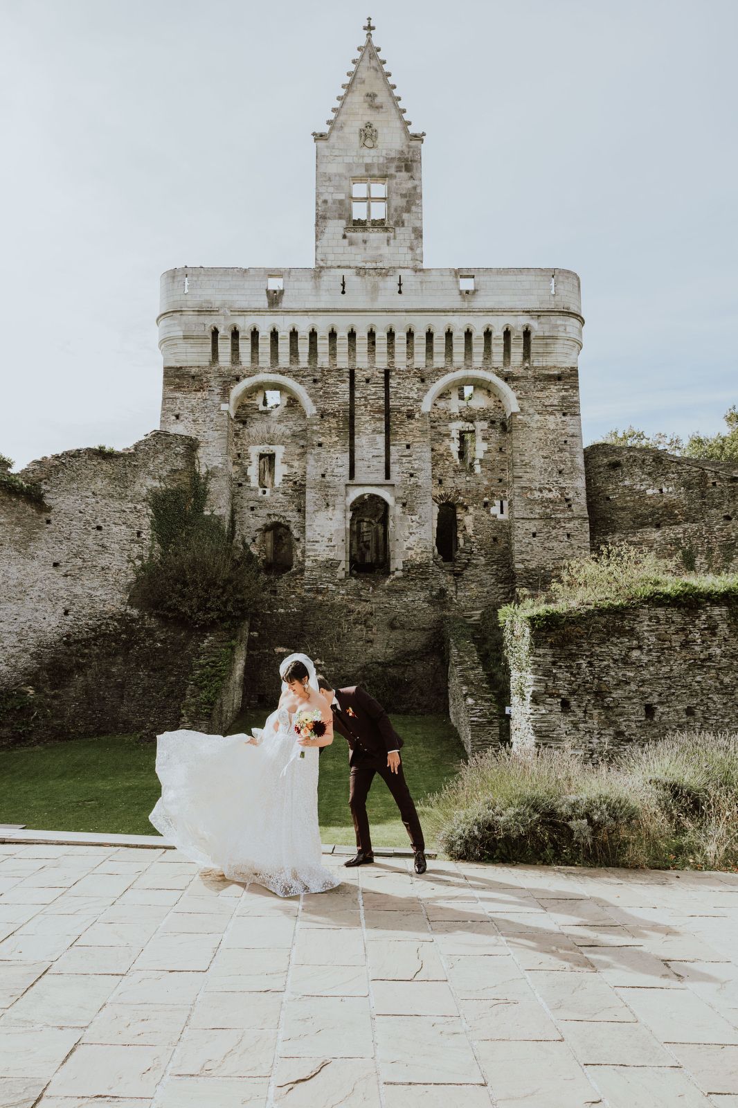 A historic stone castle with Gothic architecture creates a dramatic wedding backdrop.
