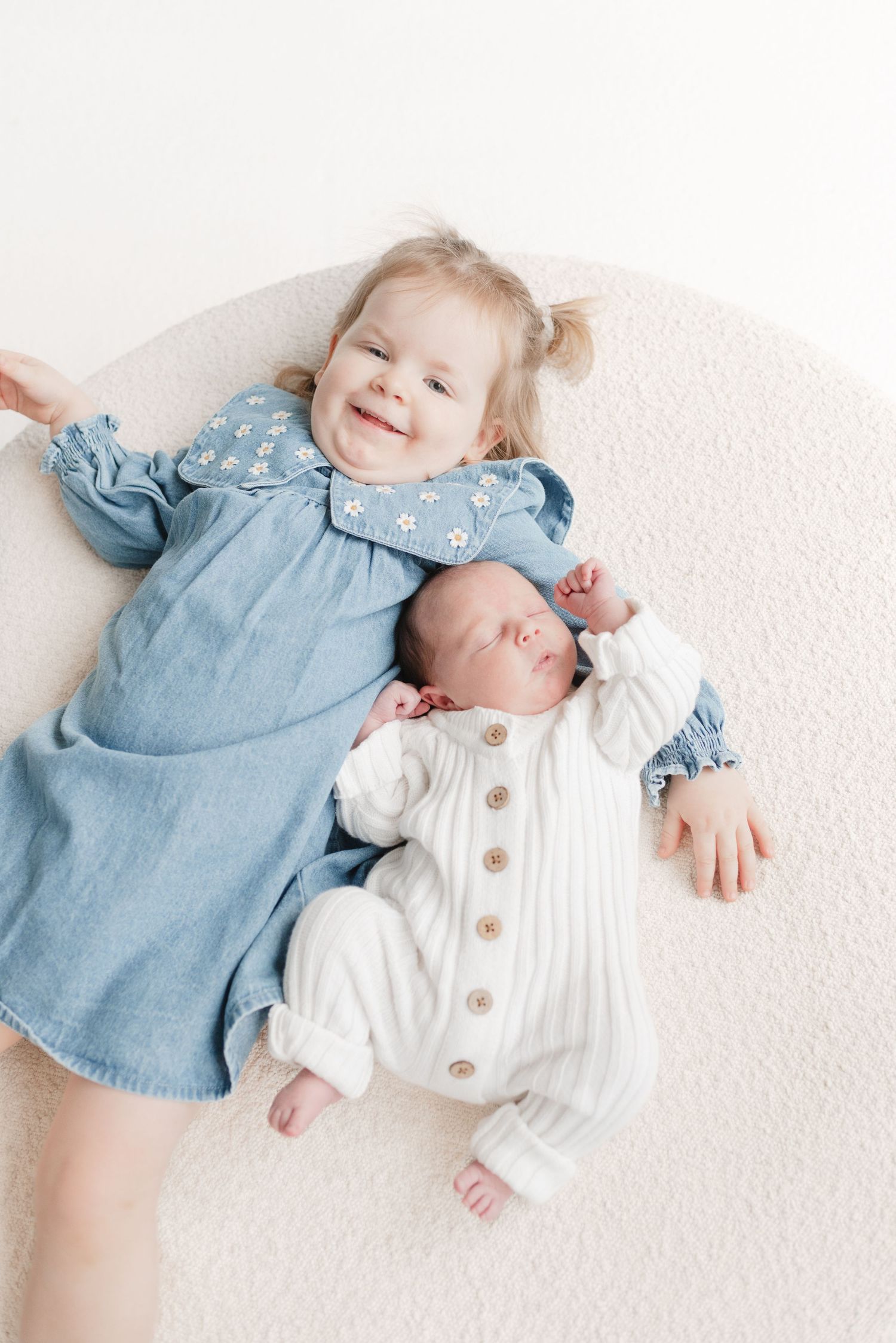 Toddler and newborn baby siblings at a light and airy lifestyle newborn photoshoot by Toronto Newborn Photographer Jess GC Photography.