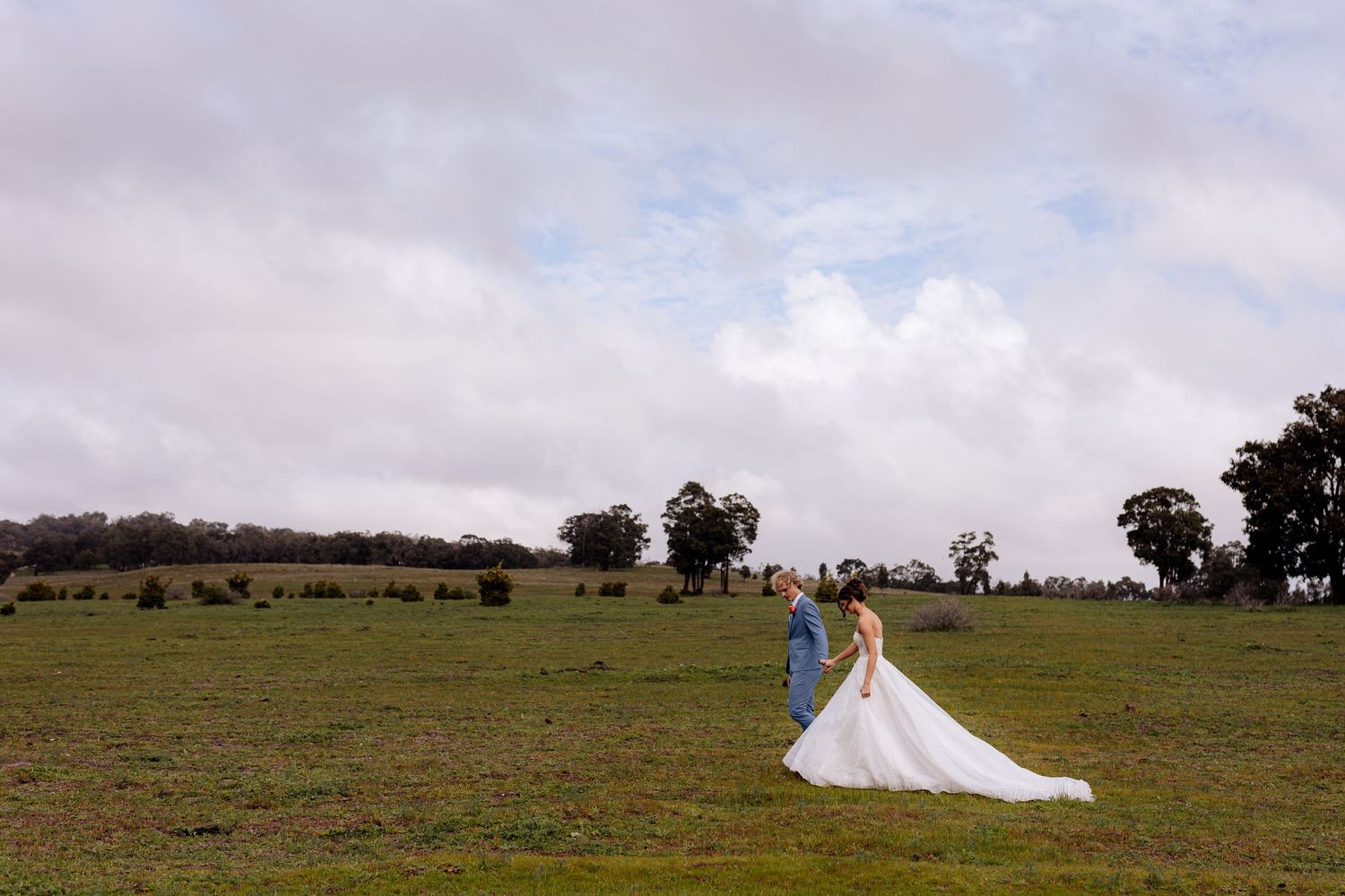 Joyful celebration as newlyweds exit their ceremony surrounded by cheering guests.