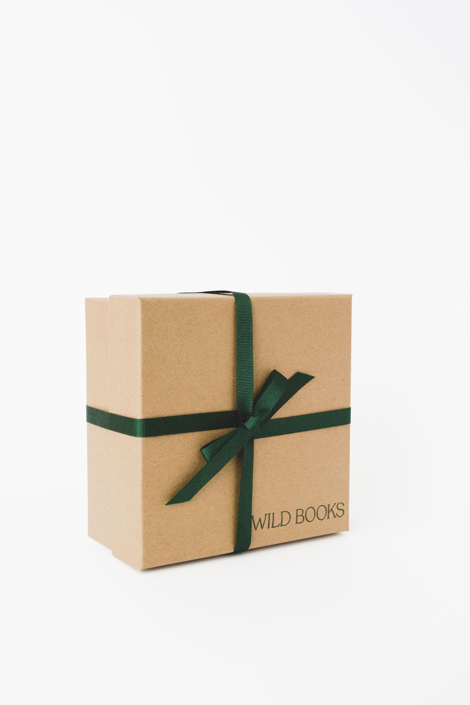 a studio pack shot photo of a brown gift box wrapped with green bow on a white background