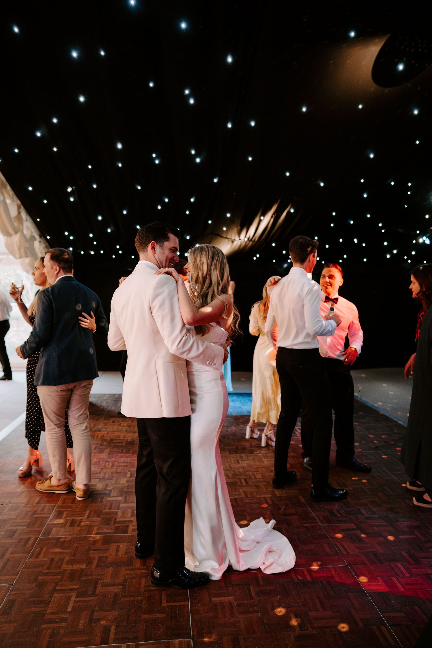 bride and groom doing their first dance surrounded by their wedding guests at hamswell house in bath