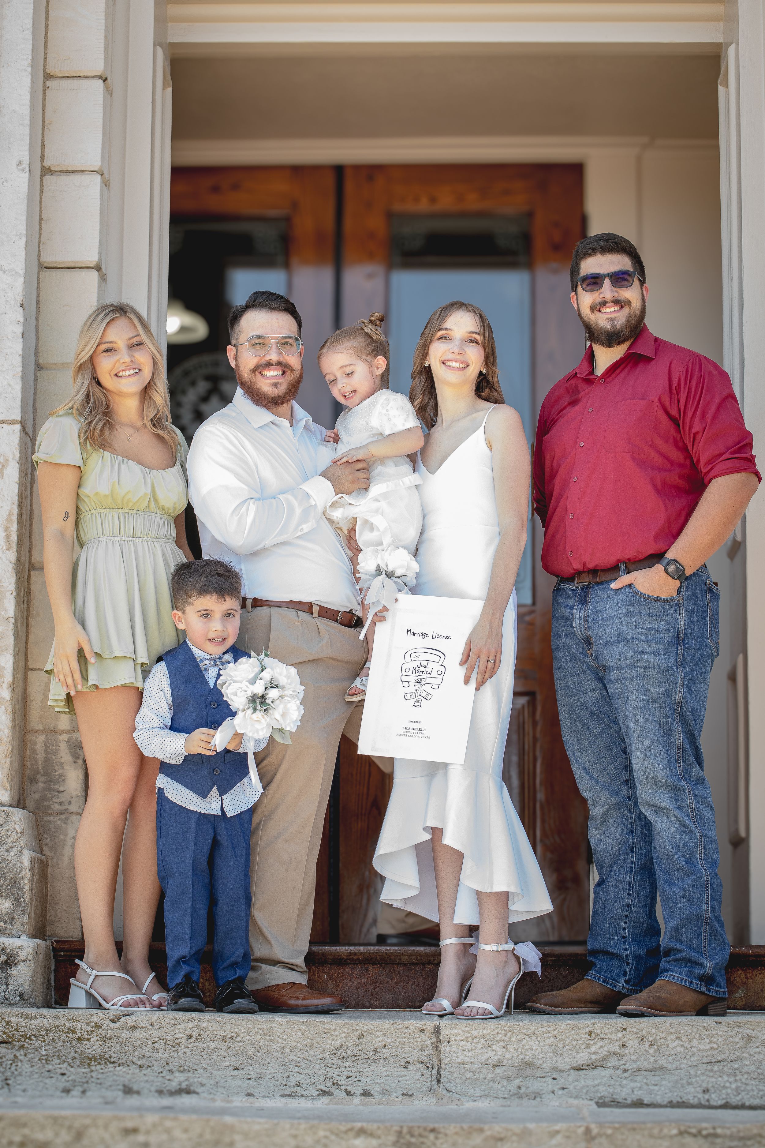 A group photo of family members in coordinated outfits standing on stone steps.