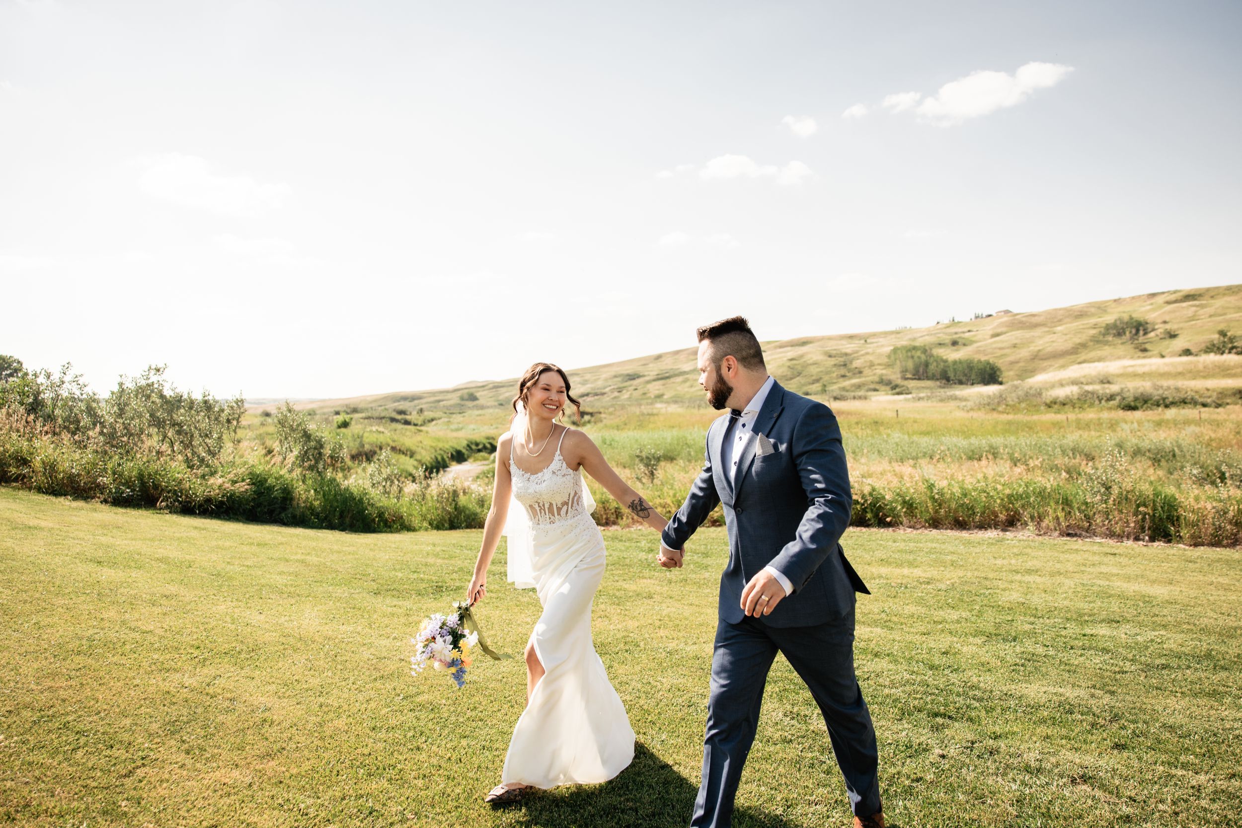 Bride and groom walking holding hands