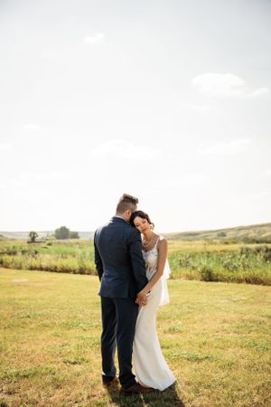 bride leaning on groom's shoulder