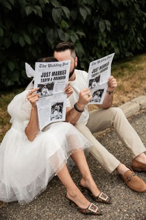 couple with their newspaper invitation