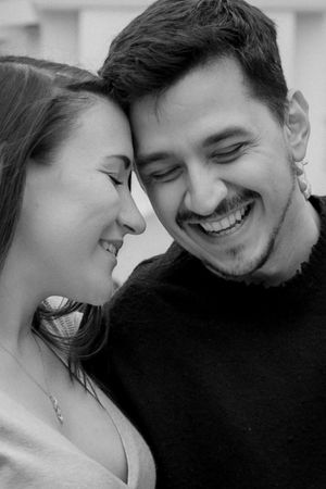Intimate black and white close-up of couple sharing loving moment with foreheads touching.