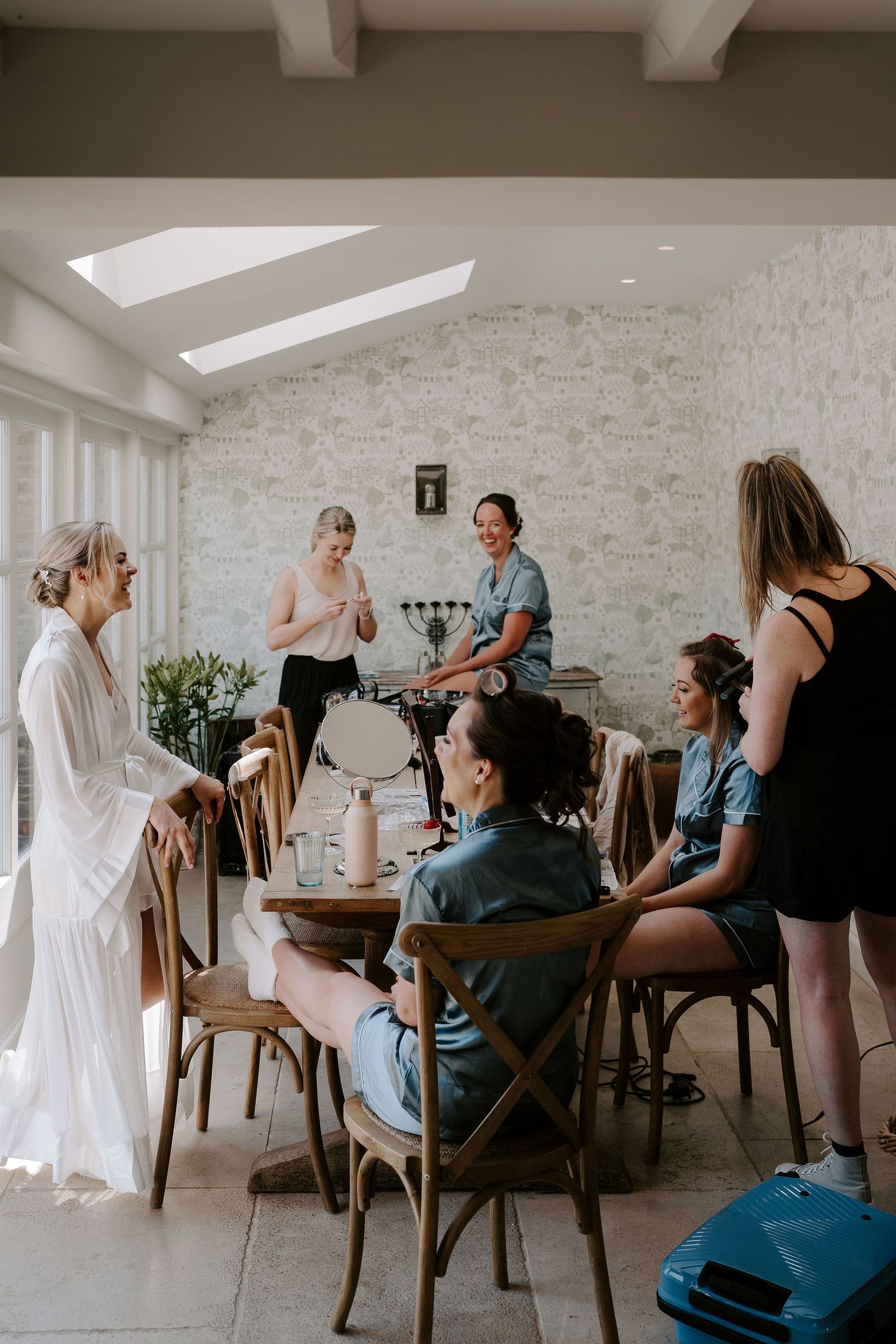bride and bridesmaids getting ready in cottage at Iscoyd park