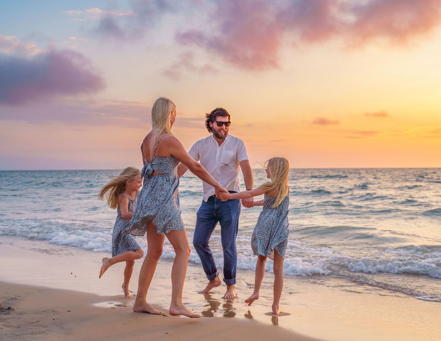 A group shares joyful and candid moments together at sunset on a beach, showing genuine warmth and connection.