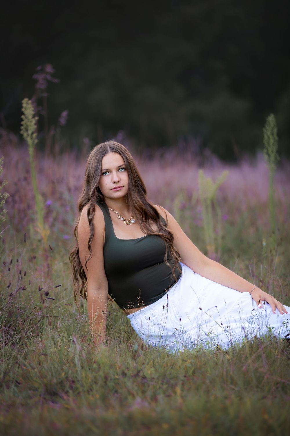 Senior portrait at Island Lake Recreation near Brighton Michigan; girl sitting in flower field by South Lyon, Michigan photographer