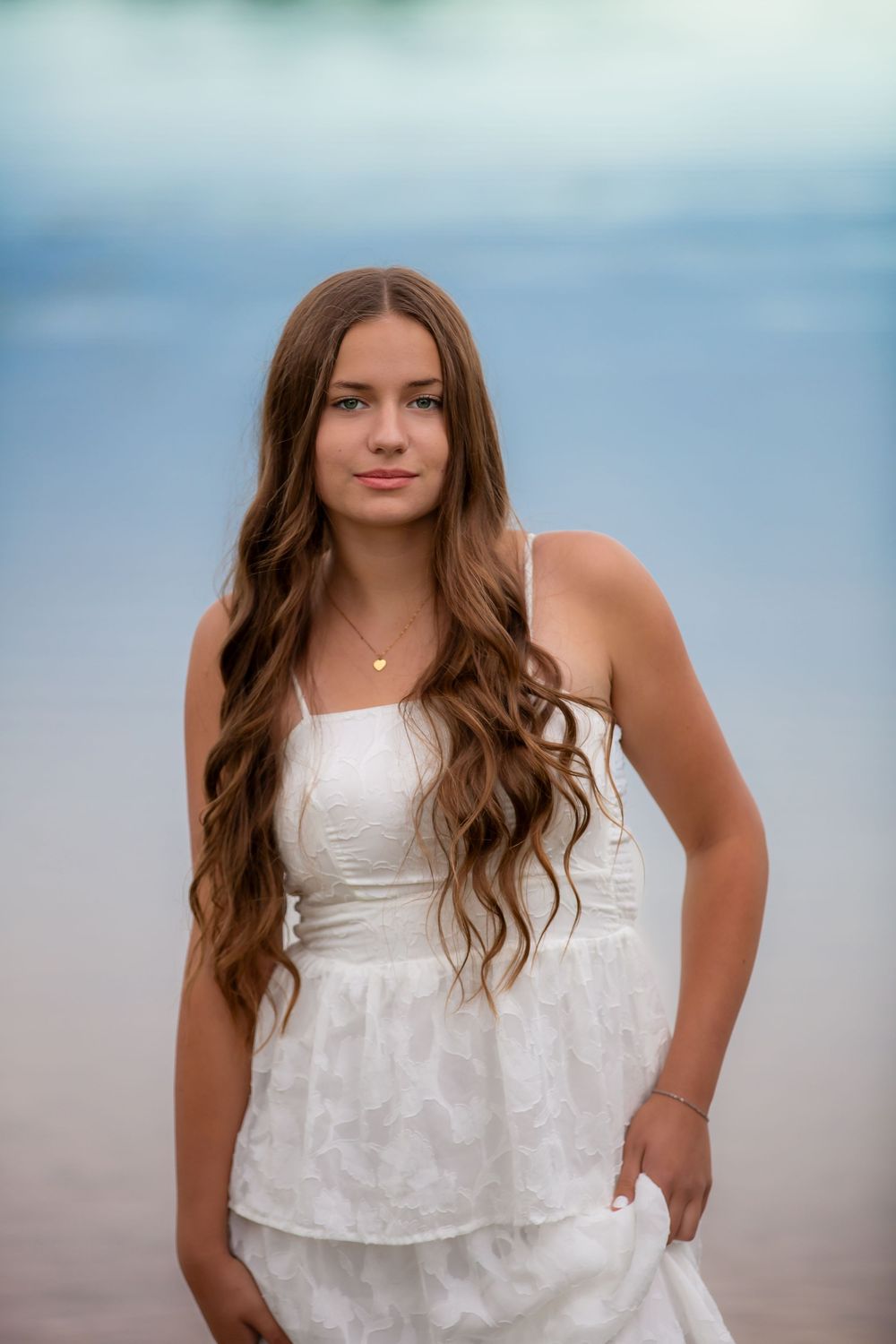 Senior portrait at Island Lake Recreation near Brighton Michigan; girl standing in lake at sunset by South Lyon, Michigan photographer