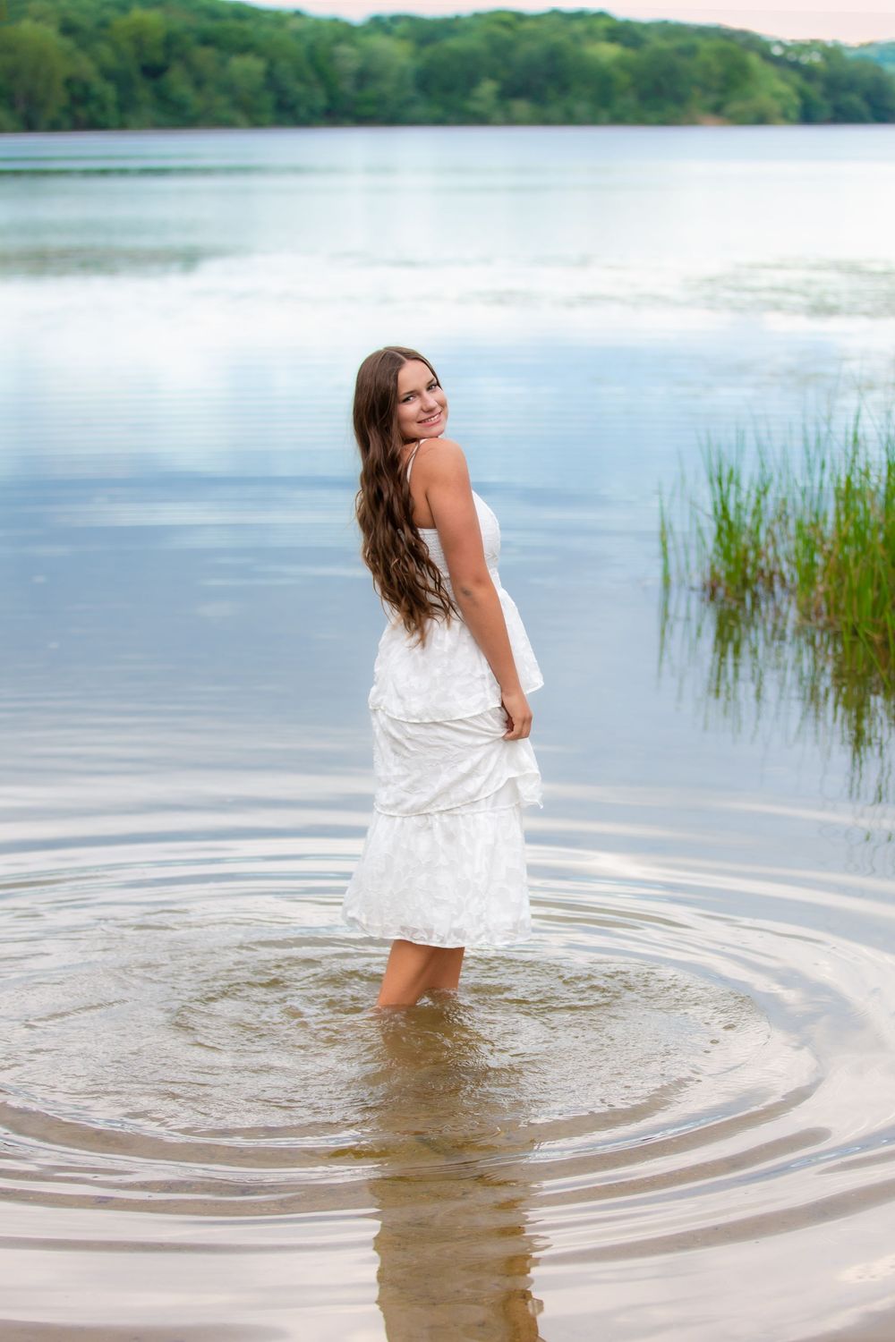 Senior portrait at Island Lake Recreation near Brighton Michigan; girl standing in lake by South Lyon, Michigan photographer